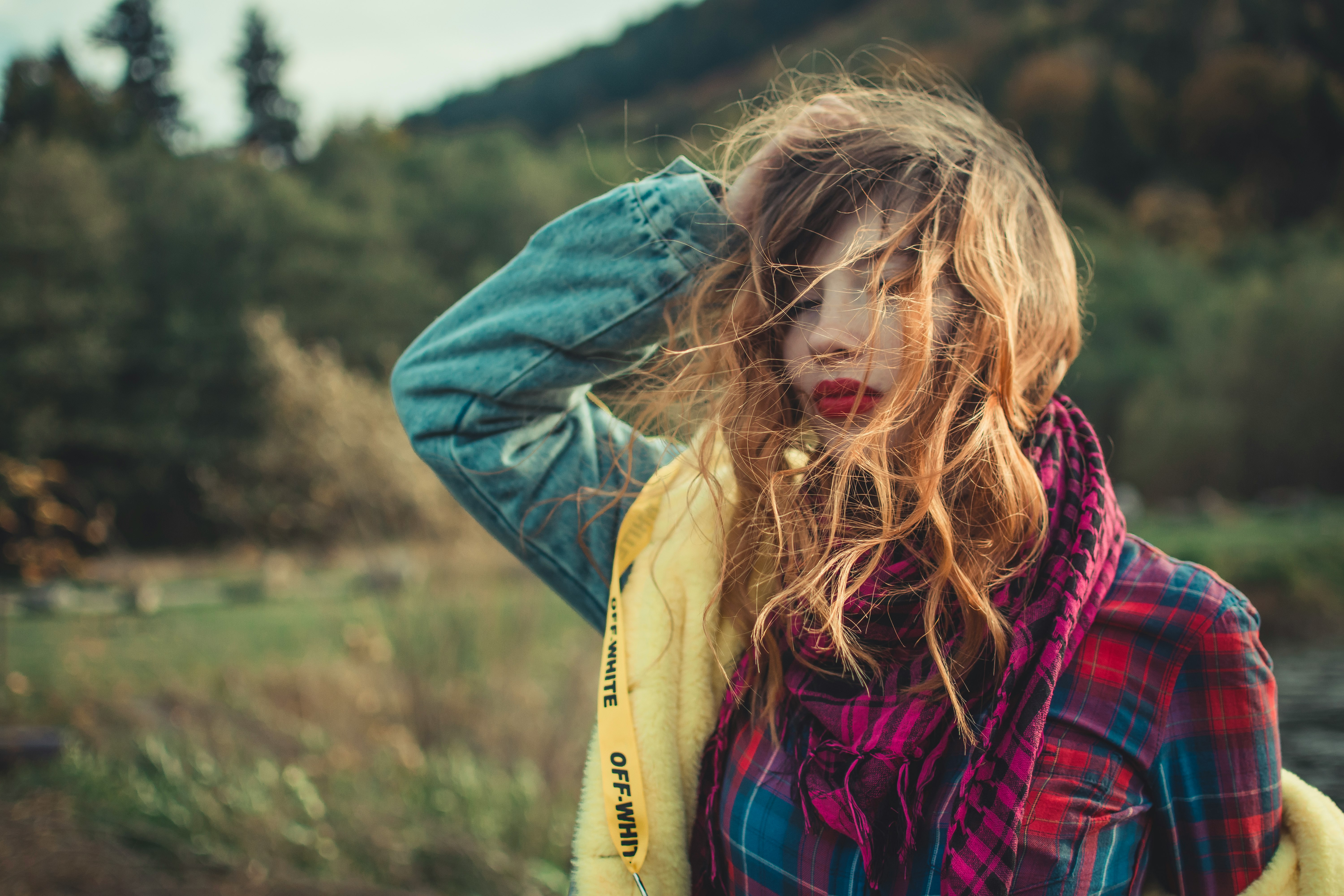 woman in plaid blouse and blue denim jacket